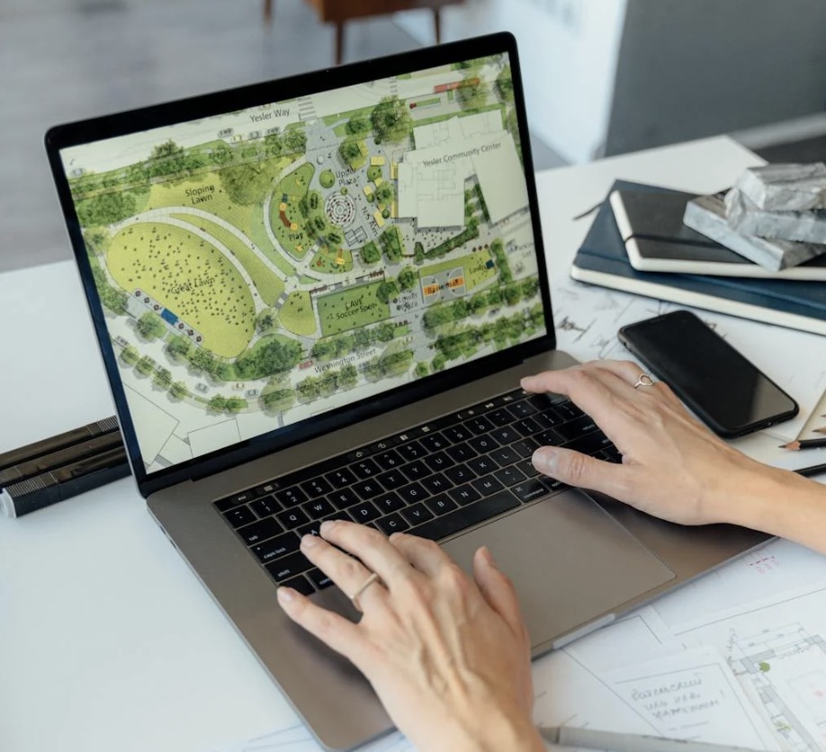 Person typing on computer displaying a map